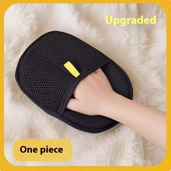 Black reusable pet hair remover mitt worn on a hand