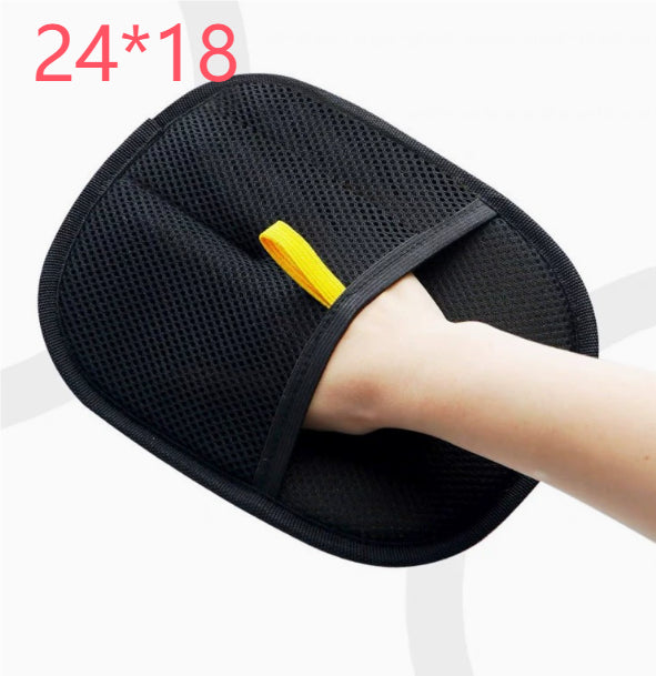 Black pet hair remover mitt worn on a hand with dimensions marked